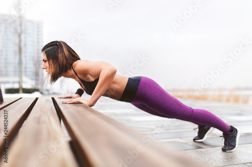 Woman perform outdoor exercises. © BigBlueStudio