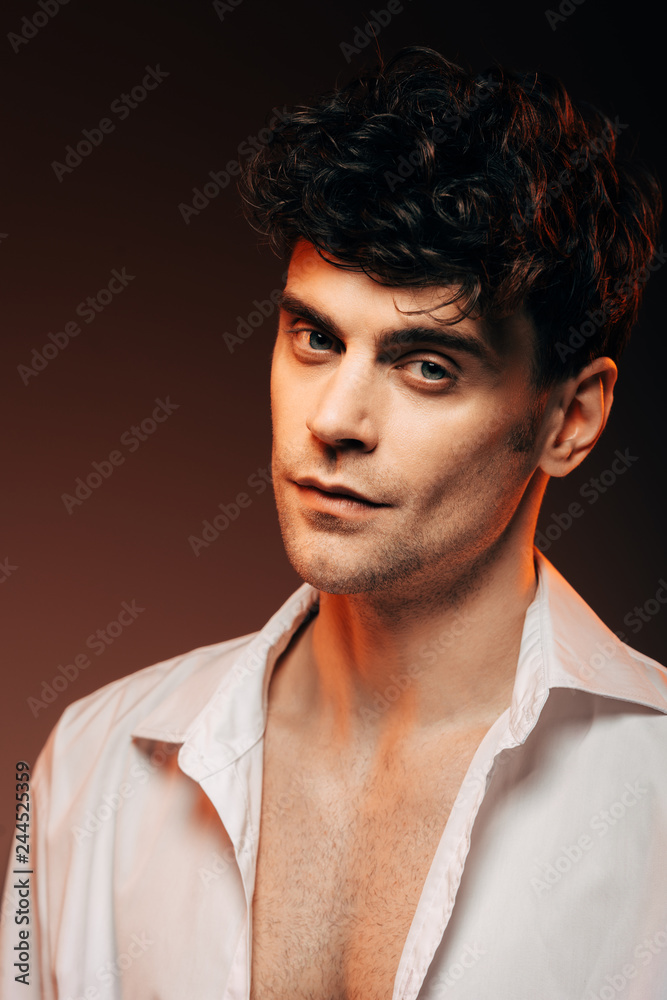 handsome man posing in white shirt, isolated on brown handsome man posing in white shirt, isolated on brown