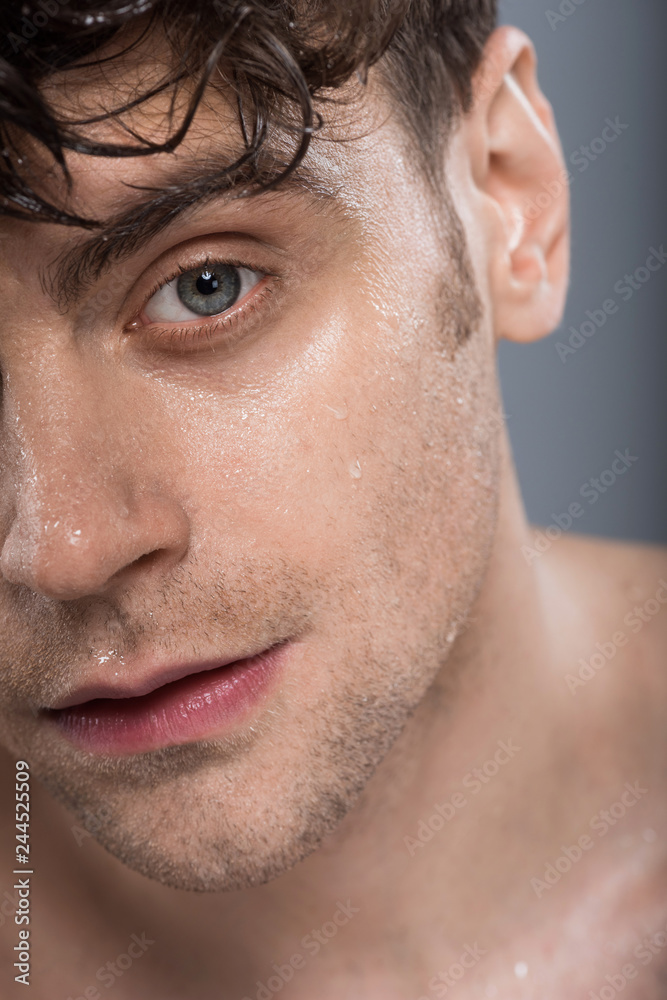 Obraz premium handsome man with wet face, isolated on grey