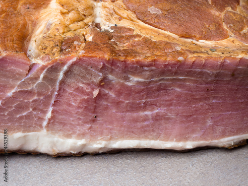 Piece of ham isolated on grey background photo