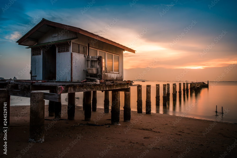 Old wooden house at sunset. Old wooden house at sunset.