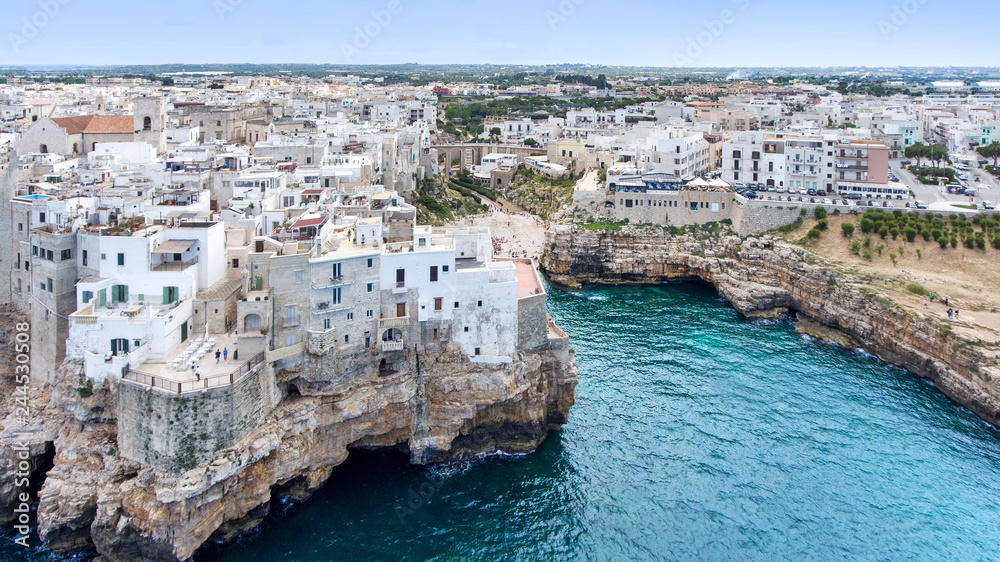 Beautiful view of old town in Polignano a Mare in Italy. Houses and buildings built on cliffs next to ocean or sea. Luxury lifestyle at the edge of the world. Concept of travelling and summer holidays
