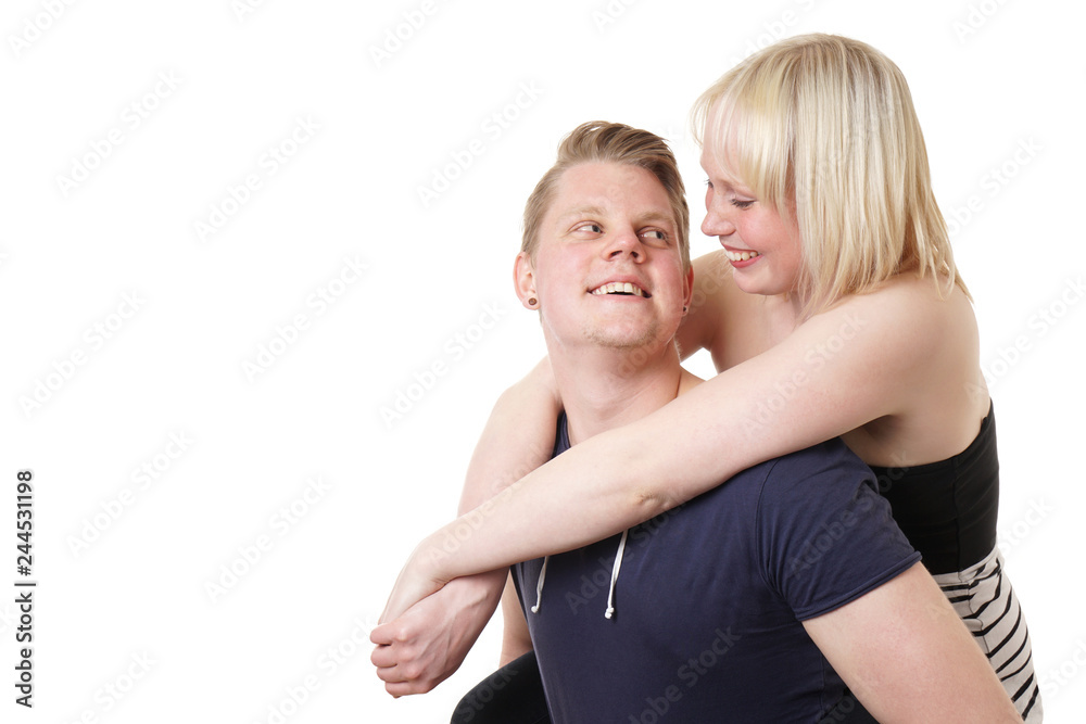 young couple piggyback having fun and smiling at each other young couple piggyback having fun and smiling at each other