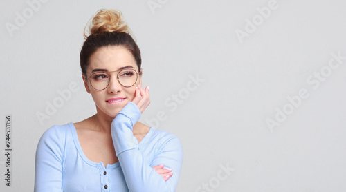 Tricky woman having plan on gray background