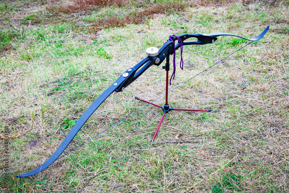 Closeup of composite bow and arrows. Background of grass. Closeup of composite bow and arrows. Background of grass.