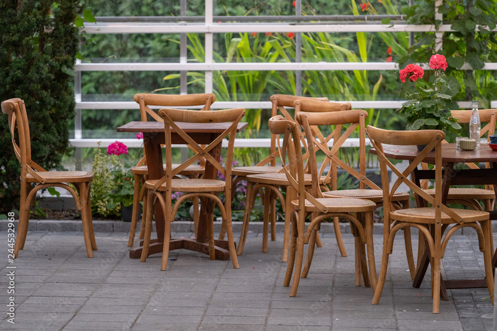 Wooden table and armchair standing outside cafe Wooden table and armchair standing outside cafe