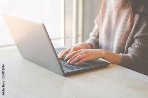 Woman working at home or office hands on keyboard laptop. Remote work freelance. Close-up.