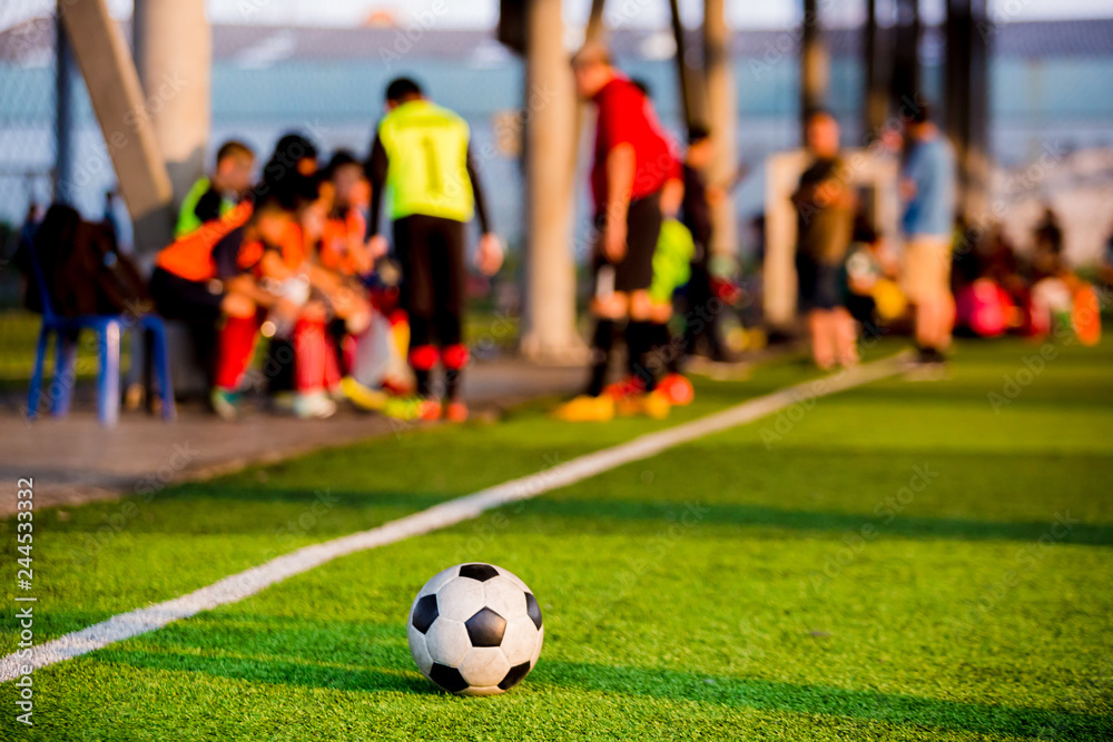 soccer ball at touchlines on artificial turf with blurry of soccer players