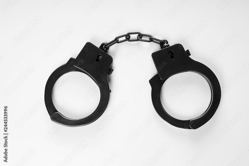 black plastic handcuffs sex toy on white background black plastic handcuffs sex toy on white background