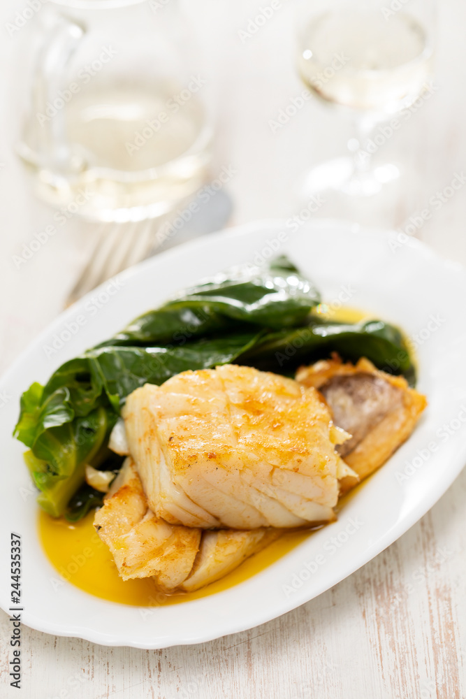 fried cod fish with cabbage on white dish fried cod fish with cabbage on white dish