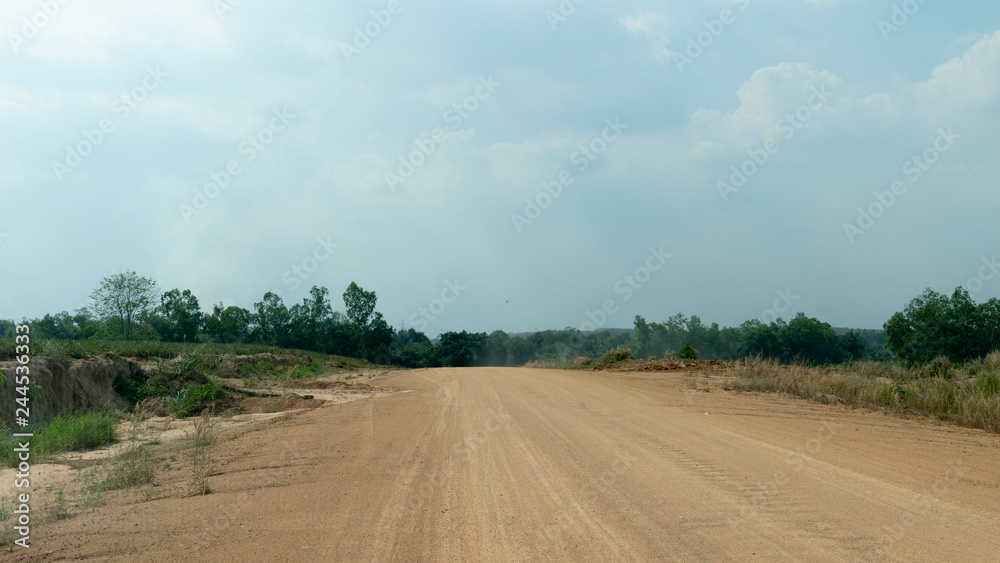 Fototapeta premium Traveling new soil road with nature of grass and tree at Ang Kep Nam Dok Krai,Mae Nam Khu, Pluak Daeng District, Rayong Thailand.