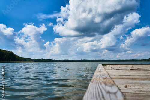 Fototapeta Naklejka Na Ścianę i Meble -  Empty footbridge over beautiful Lemiet lake in Mazury district, Poland. Fantastic travel destination.