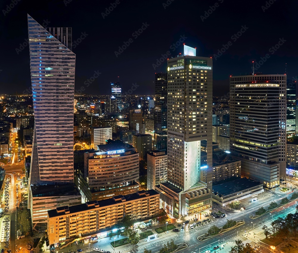 Naklejka premium Warsaw, Poland - August 27, 2016: Aerial panoramic view to downtown of Polish Capital by night, from the top Palace Culture and Science: Palac Kultury i Nauki, also abbreviated PKiN.