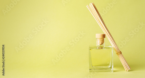 Aroma reed diffuser home fragrance with rattan sticks with glass bottle. Tropical green mood blank background for your own design. long wibe bunner. photo