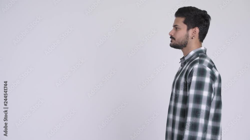 Profile view of young handsome bearded Indian man Profile view of young handsome bearded Indian man