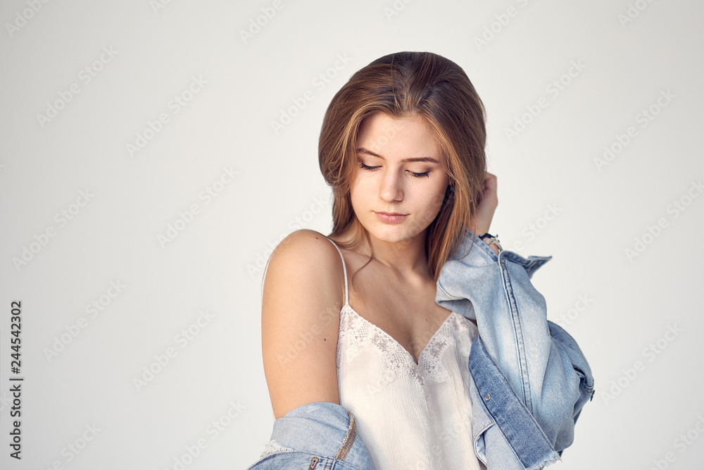 Portrait down shy female, smiling girl looking down shyly isolated white background wall. Positive human emotion facial expression attitude - Image Portrait down shy female, smiling girl looking down shyly isolated white background wall. Positive human emotion facial expression attitude - Image