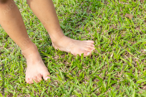 Baby's foot stepping on the grass.