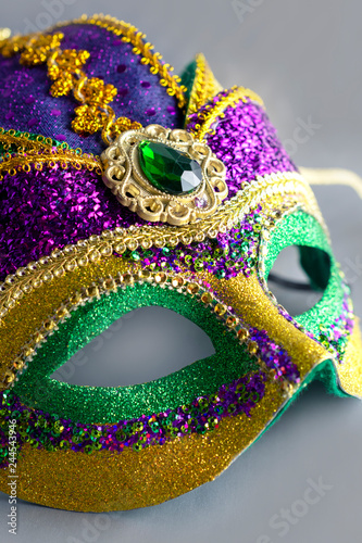 Jester mask with large gem. Portrait crop with grey background. Object only. No people.