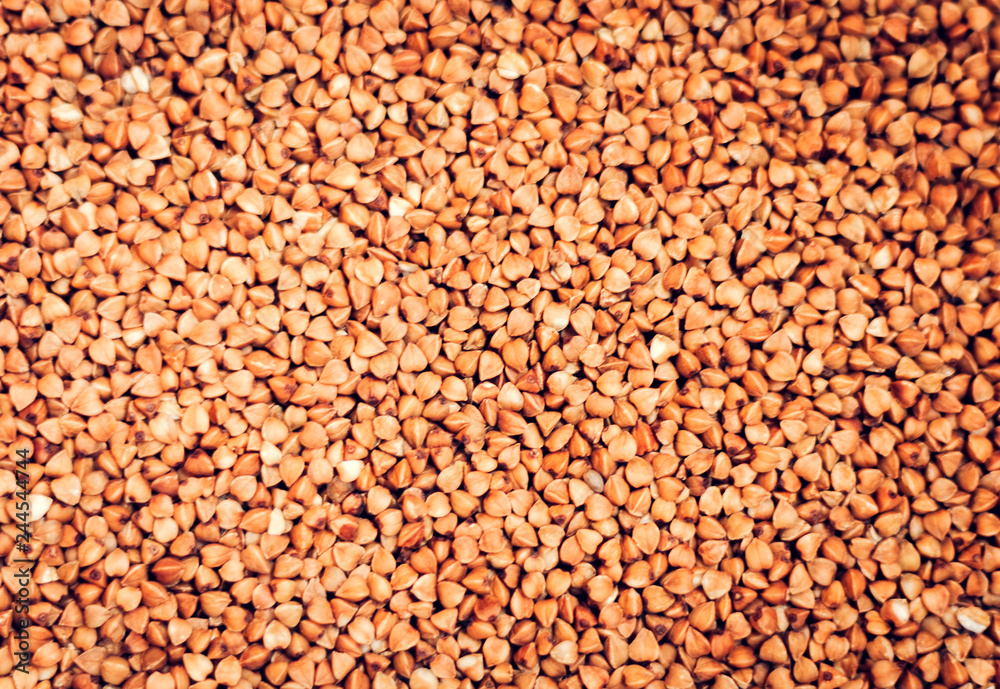 Dry raw buckwheat grains background texture vegetarian concept. Dry raw buckwheat grains background texture vegetarian concept.
