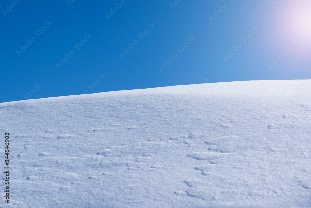 A heap of snow against the blue sky