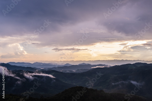 Silhouette mountain layers with sea of fog, sky, cloud and sunrise at Khun Yuam, Mae Hong Son, Thailand