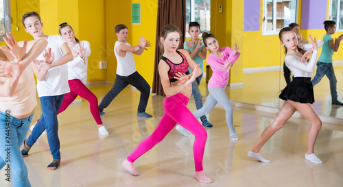 Teenagers practicing dance with female trainer