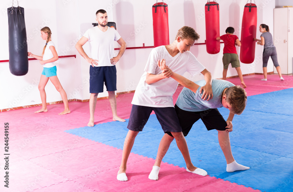 Fototapeta premium Kids practicing in pair self-protection