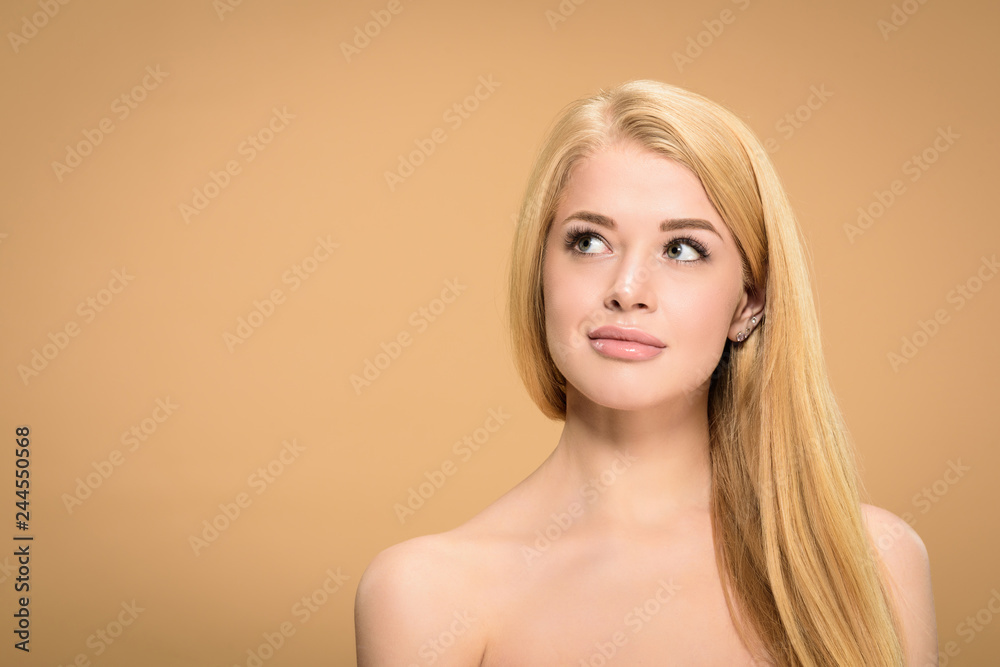 Studio shot of curious blonde woman looking up Studio shot of curious blonde woman looking up