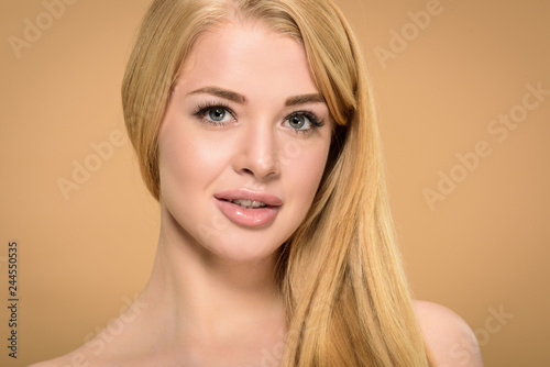 Studio shot of blonde young woman with grey eyes