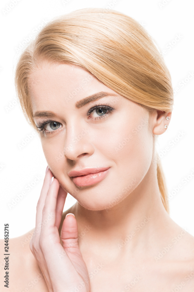 close-up view of beautiful young blonde woman touching face and looking at camera isolated on white close-up view of beautiful young blonde woman touching face and looking at camera isolated on white