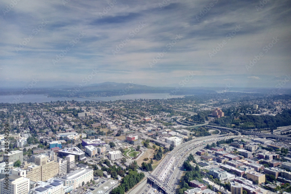Seattle, USA - September 2, 2018: Aerial view overlooking the city skyline of Seattle Washington with mountain ranges on distant horizon.