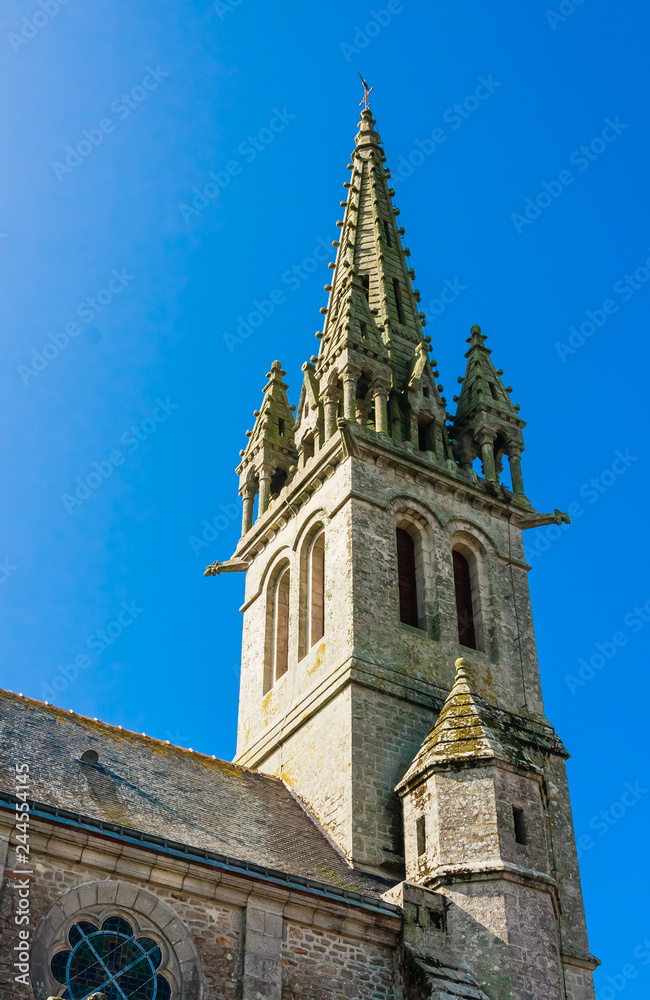 Fragment of The bell tower of the Church of St. Peter and Notre-Dame-de-Lorette sits in the middletown of Redene. Brittany, France