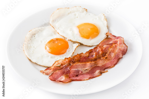 Fried eggs and bacon for breakfast isolated on white background. Close up

