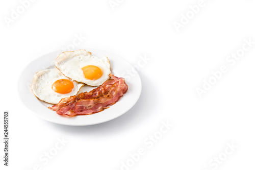 Fried eggs and bacon for breakfast isolated on white background. Copyspace

