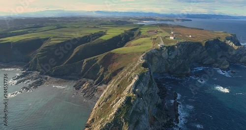 Backward movement in an general aerial view moving away from the coastline with a lot of cliffs