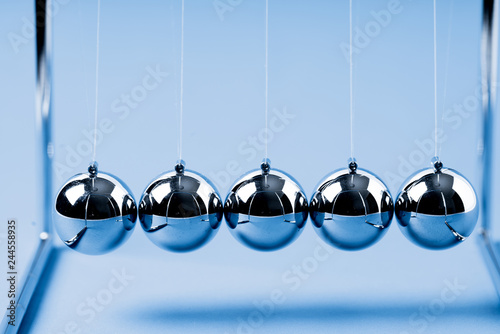 Newtons Cradle balancing balls, business concept in studio