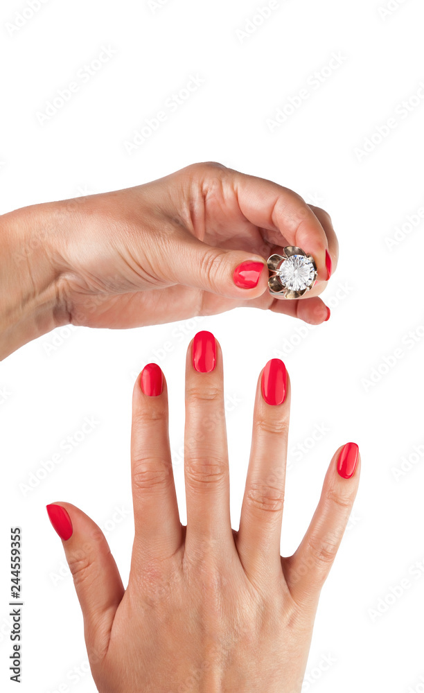Female hands with red manicure wear a silver ring Female hands with red manicure wear a silver ring