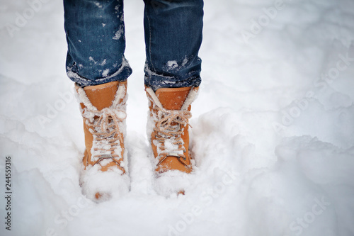 Boots in the snow, woman's boots walking snow weather copy space