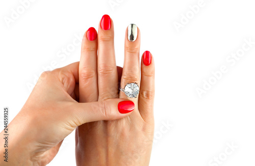 Female hands with red manicure wear a silver ring