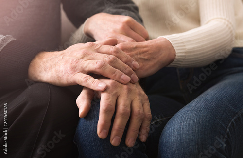 Together till end. Elderly couple holding hands