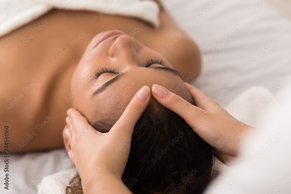 Woman enjoying anti aging facial massage in spa salon - obrazy, fototapety, plakaty 
