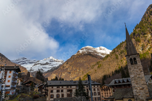 Mountain panorama with peaks, snow, villages, streams and trails