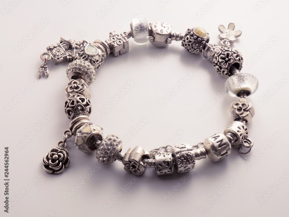 Silver color bracelet on a white background with a shadow Silver color bracelet on a white background with a shadow