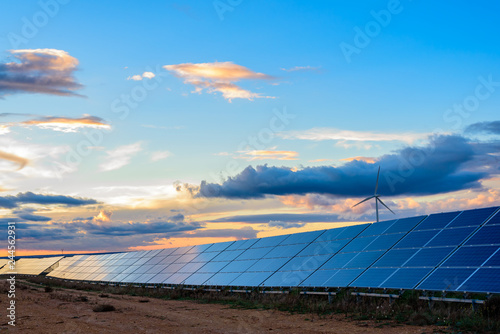 Photovoltaic and wind plant at sunset