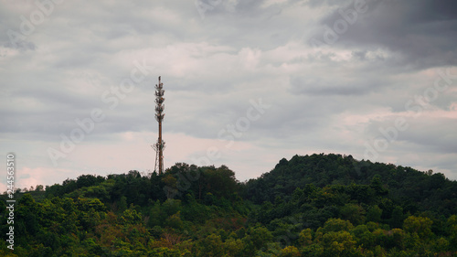Aerial view of communication Tower on top of hill with clouds