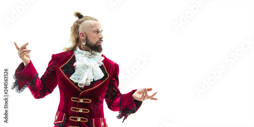 The young man wearing a traditional medieval costume of marquis posing at studio. Fantasy, Antique, Renaissance concept
