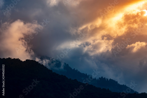 dramatic sunset in the mountains. Summer background.