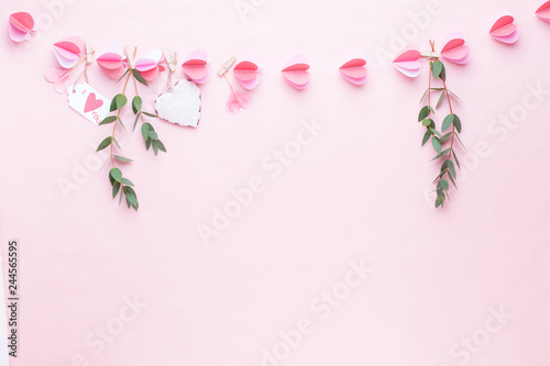 Colorful paper garland of hearts on the living coral background. Valentine day greeting cards. © gitusik