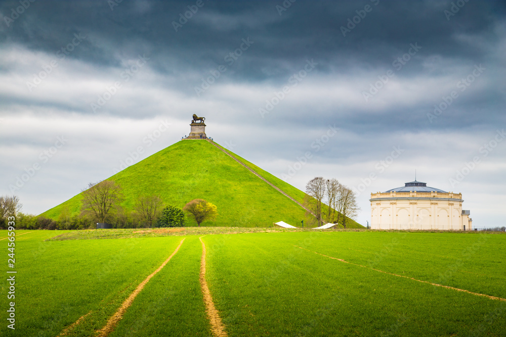 Famous Lion's Mound memorial site at the battlefield of Waterloo with dark clouds, Belgium