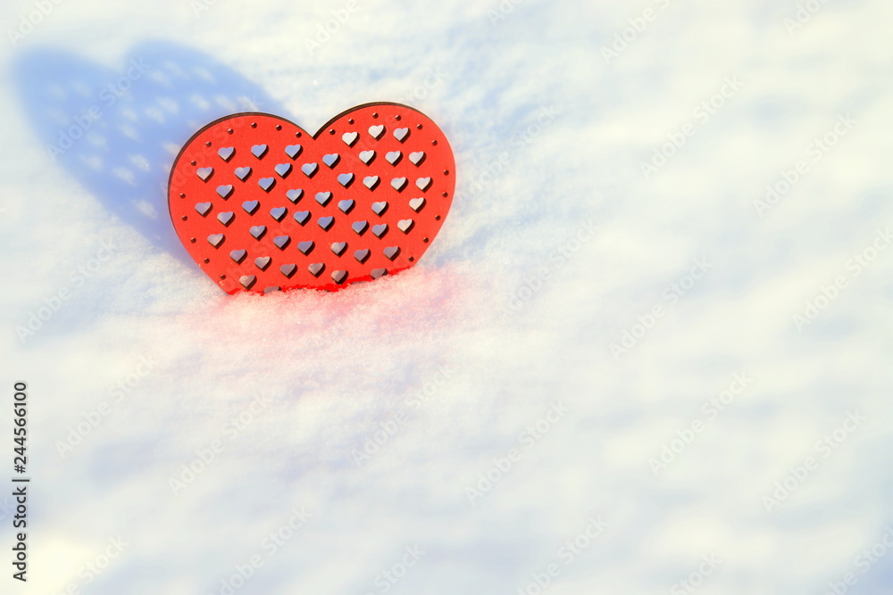 Fototapeta premium Valentines Day red heart in winter. Red wooden heart in the snow , winter scene with love message.